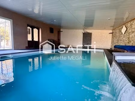 grande maison en pierre avec piscine intérieure
