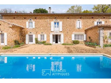 belle bâtisse en pierre au coeur d'un parc arboré avec piscine