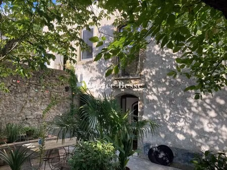 au coeur d'un village du pays cathare  une bâtisse de caractère et son jardin paysagé de..