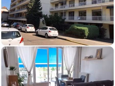 grand immeuble traversant / double balcon / garage privatif / cave