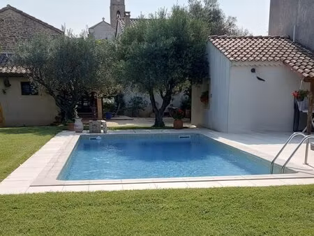 dans village avec commerces  charmante maison en pierre avec jardin et piscine.
