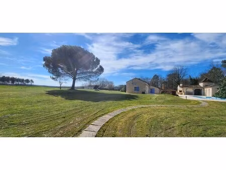 maison en pierres de plain-pied avec étang et piscine dans un environnement boisé...
