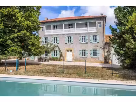stone presbytere in a hamlet with mountain views