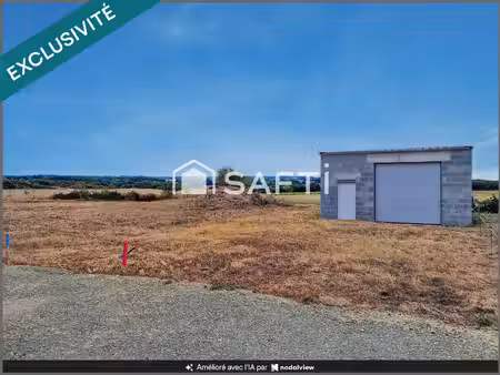 beau terrain à bâtir avec grand garage déjà édifié